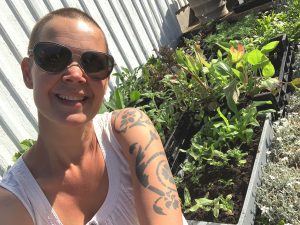 Sara sitter bredvid massor av små plantor.