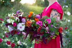 Sara håller ett stort fång blandade blommor.